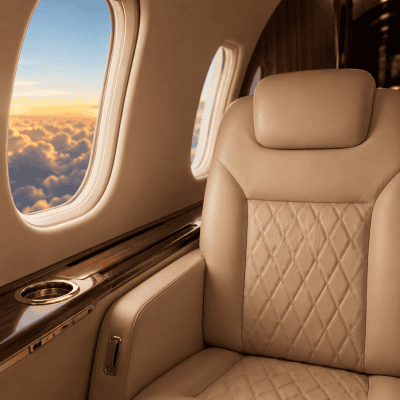 Luxury private jet cabin with premium leather seating and sunset view